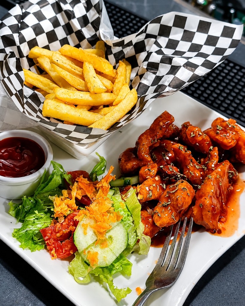 Saucy chicken with fries and side salad at Dee's Riverside Café